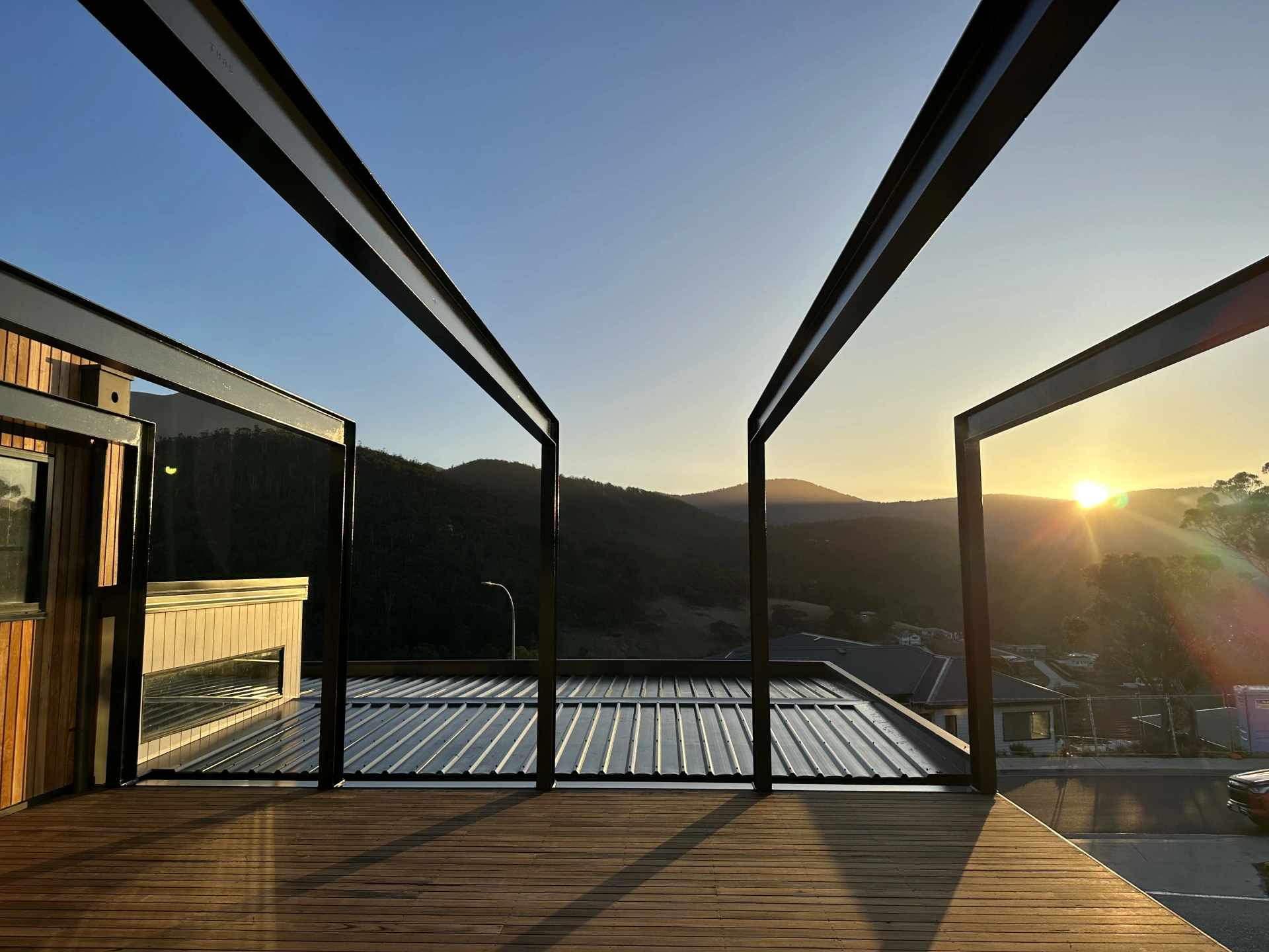 Architectural steelwork framing a residential deck in Lenah Valley at sunset