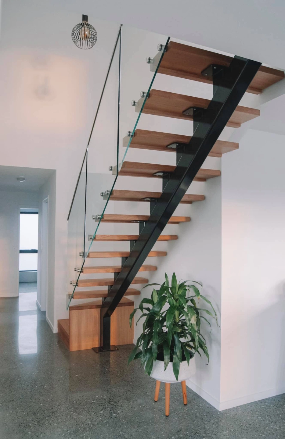 Floating steel and timber stair with glass balustrade in Oakdowns